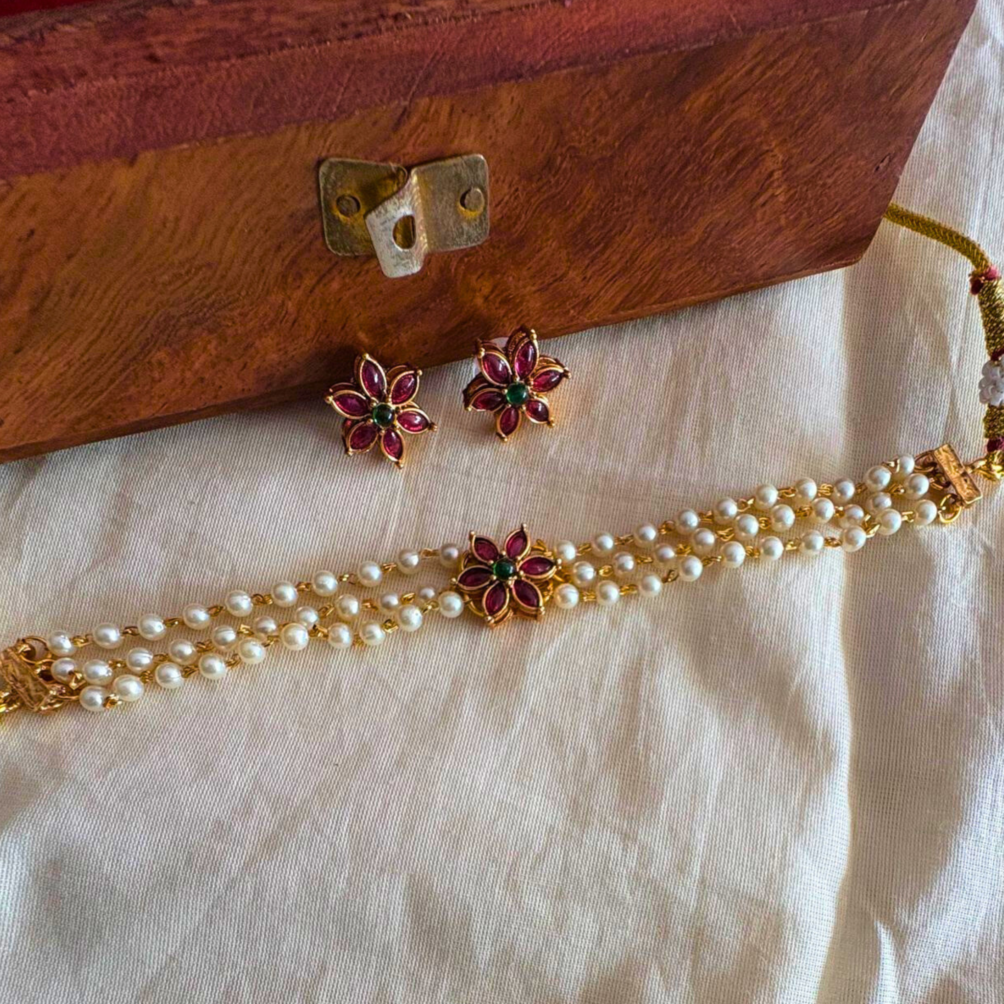 Three-layer white pearl choker with red and green Kemp floral pendant and matching stud earrings